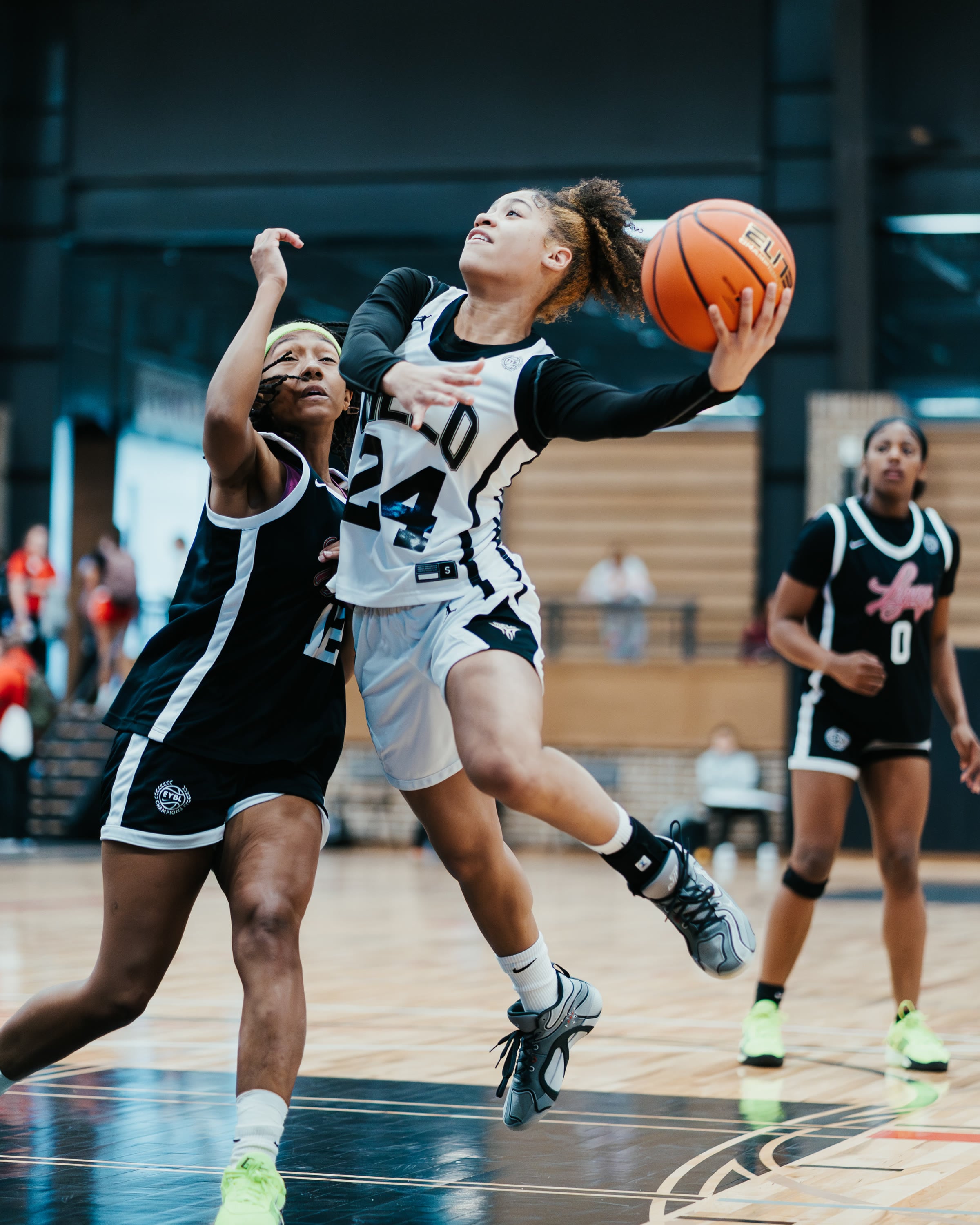 Basketball player driving to the layup at an EYBL tournament