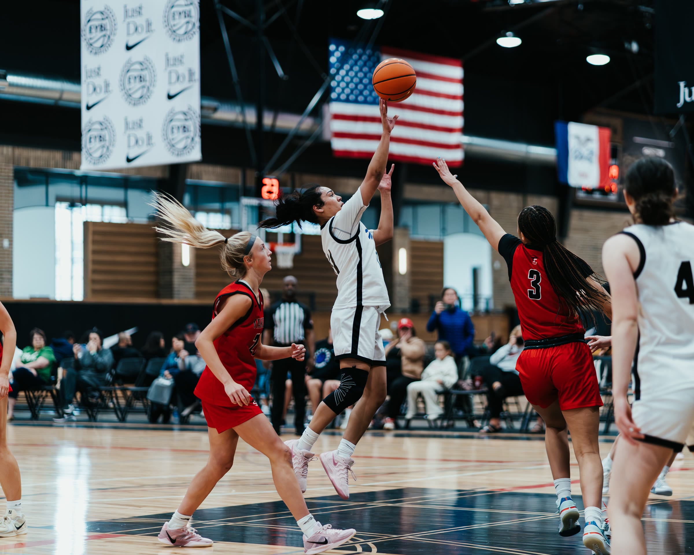 Basketball player driving to the basket at an EYBL tournament
