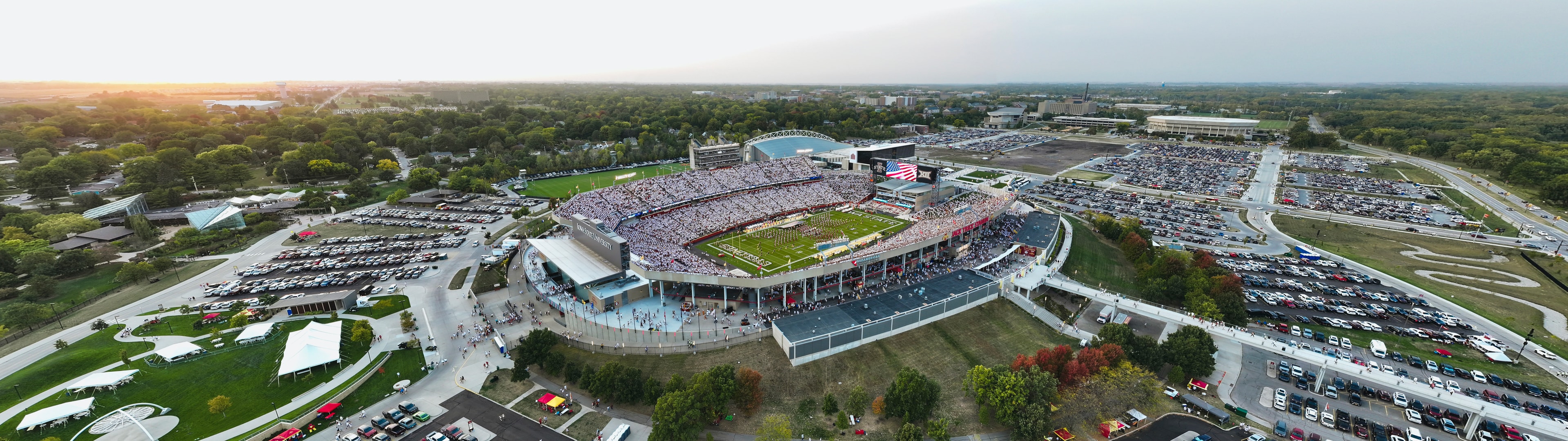 Wide aerial panorama of Jack Trice Stadium and the surrounding campus on gameday