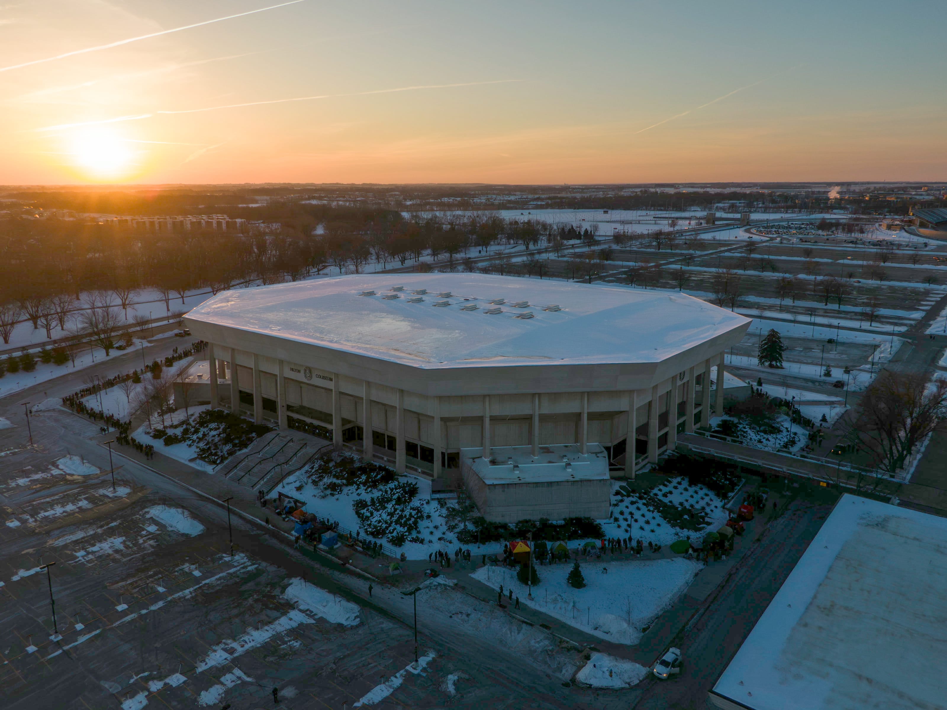 Aerial winter sunset view of Hilton Coliseum with snow on the ground