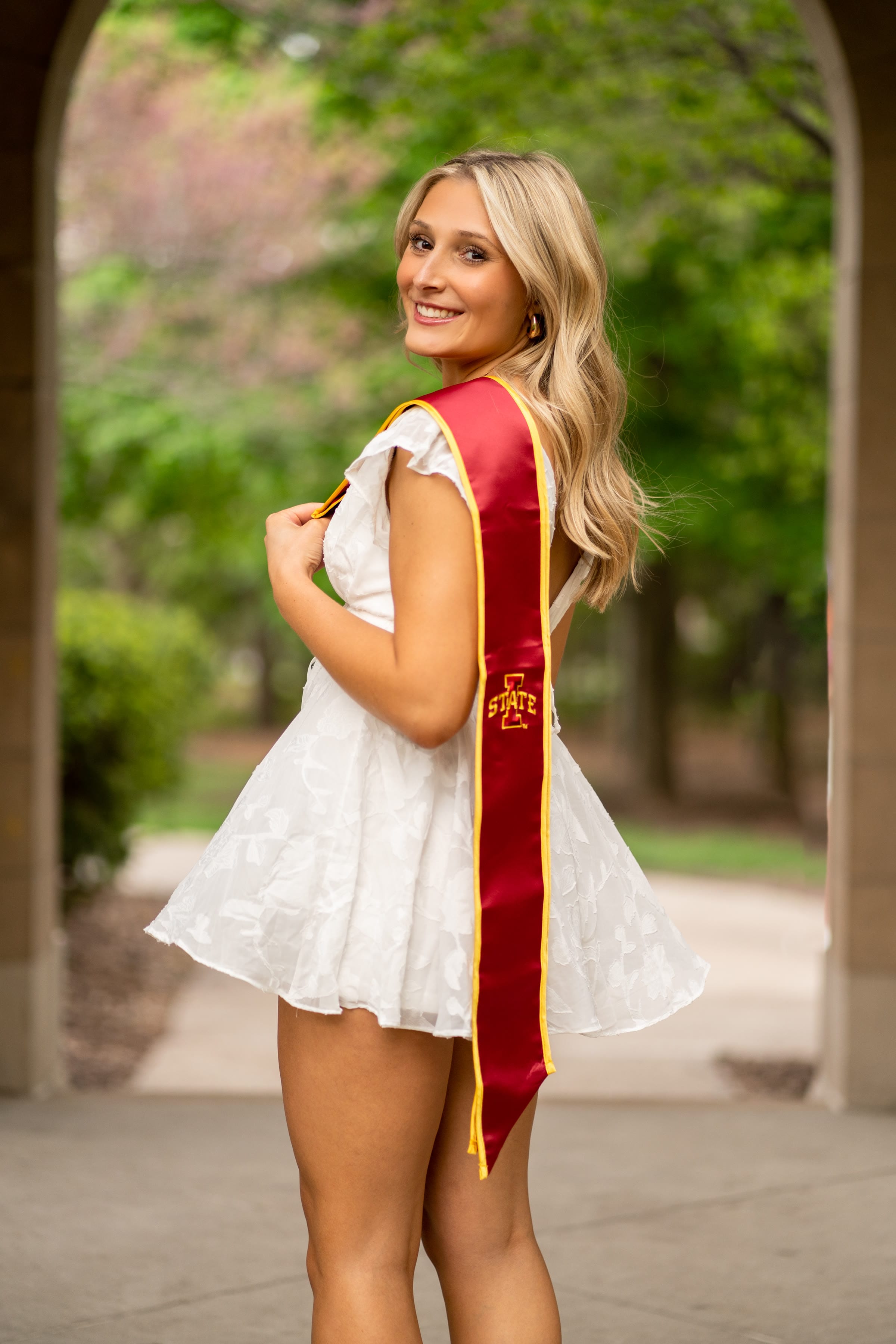 Graduation portrait under a campus archway