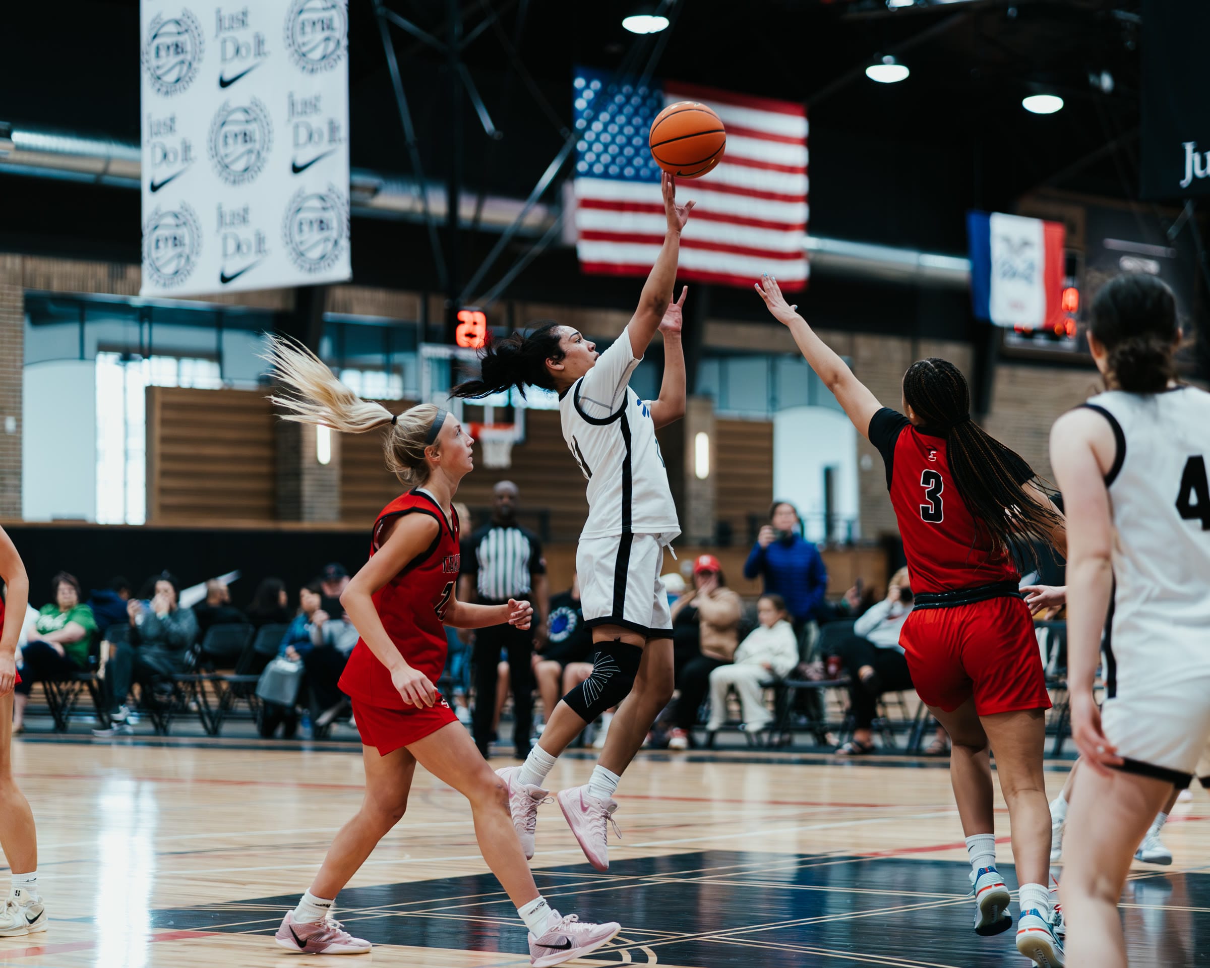 Basketball player driving to the basket at an EYBL tournament