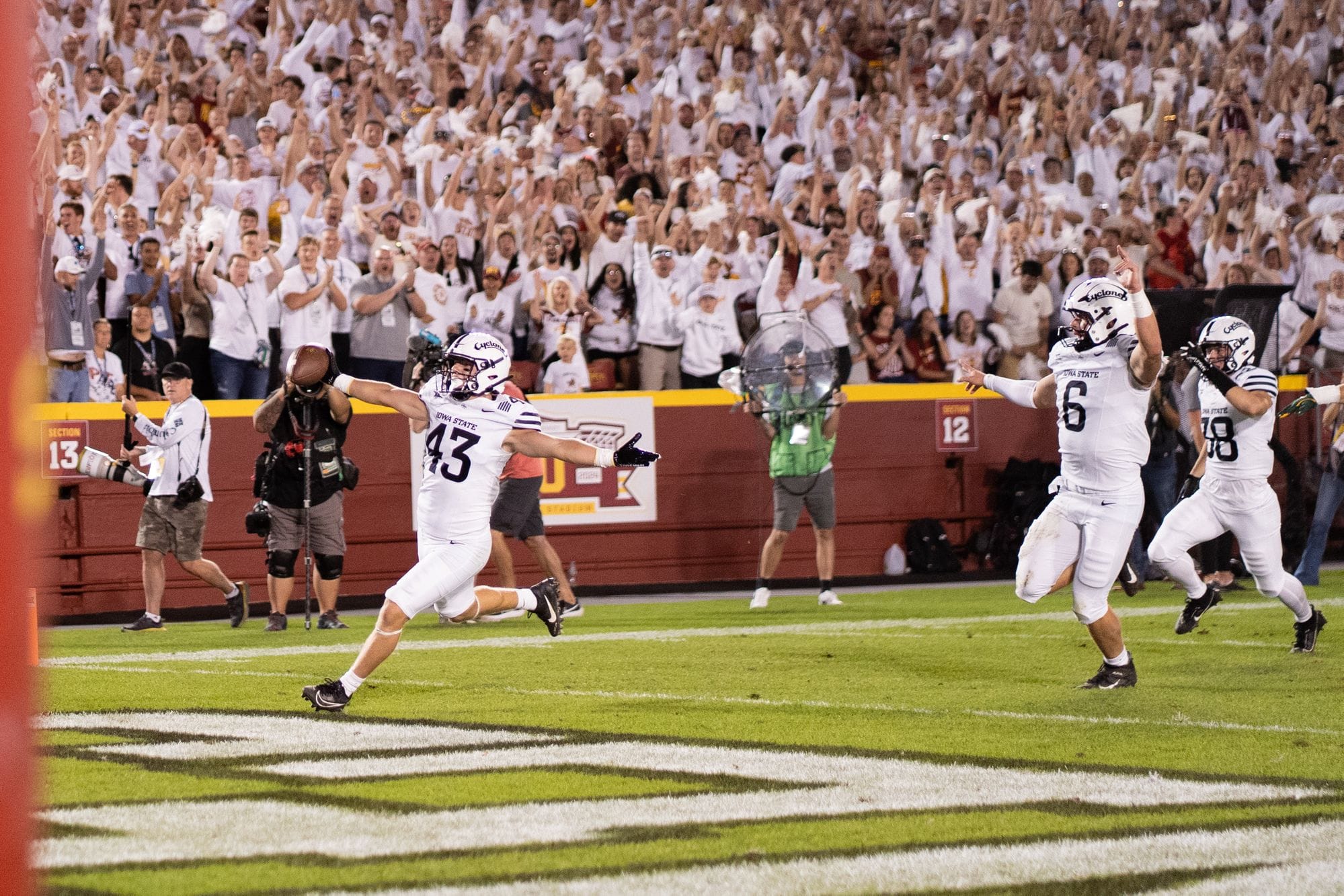 Iowa State football player leaping into the end zone in celebration