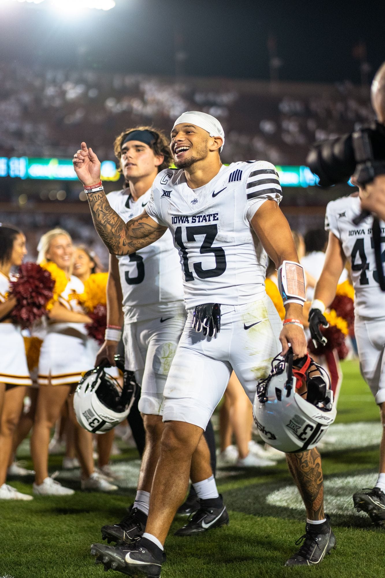 Football player smiling and celebrating on the sideline after a win